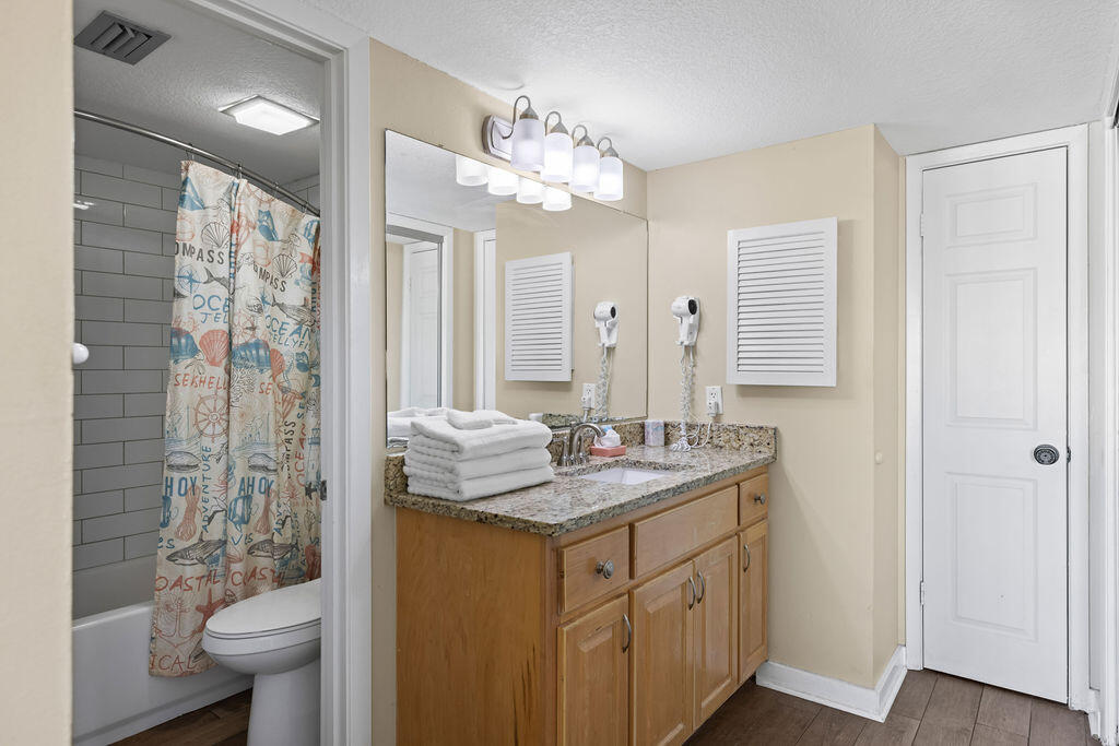 909 Santa Rosa Boulevard, Unit 569 Fort Walton Beach, FL 32548 - Photo 24 of 57 a bathroom with a granite countertop sink toilet and shower