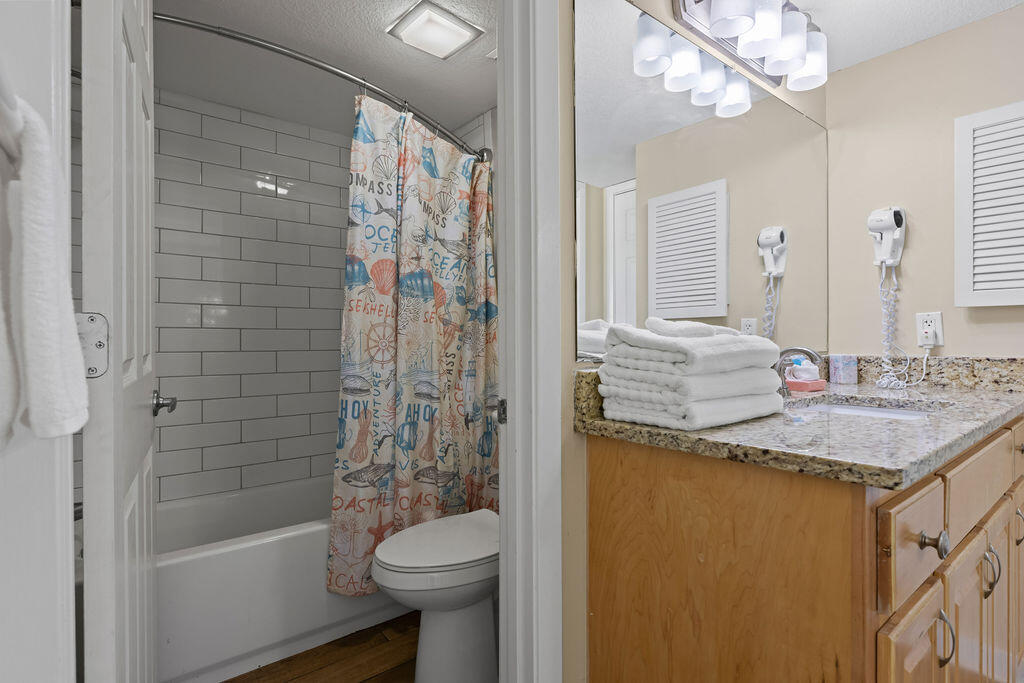 909 Santa Rosa Boulevard, Unit 569 Fort Walton Beach, FL 32548 - Photo 25 of 57 a bathroom with a granite countertop sink toilet and shower