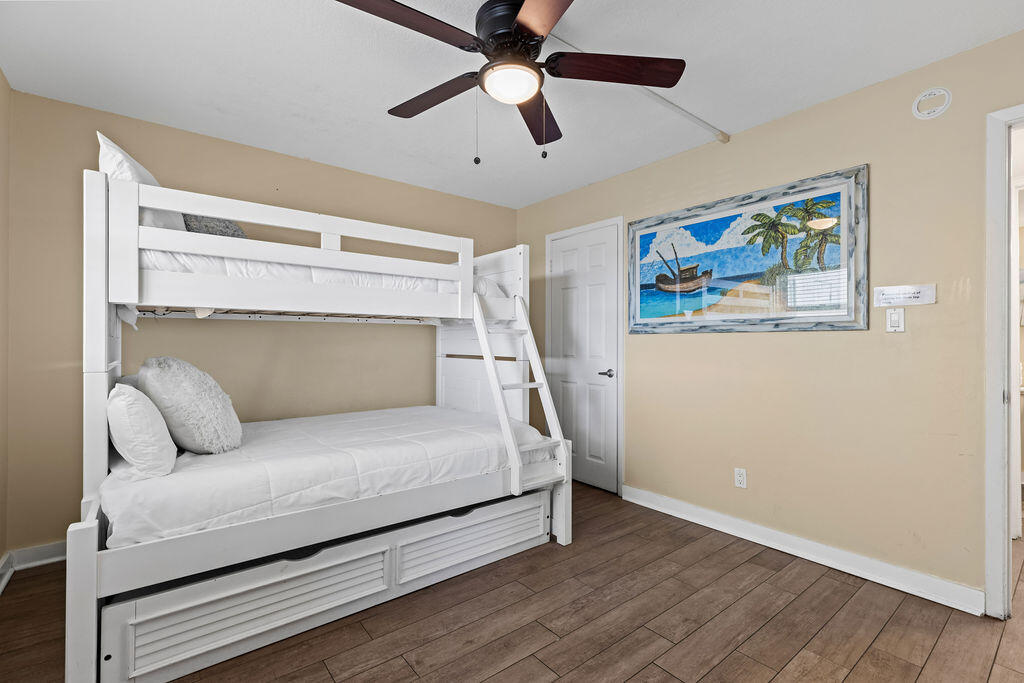 909 Santa Rosa Boulevard, Unit 569 Fort Walton Beach, FL 32548 - Photo 27 of 57 a bedroom with a bed and a ceiling fan