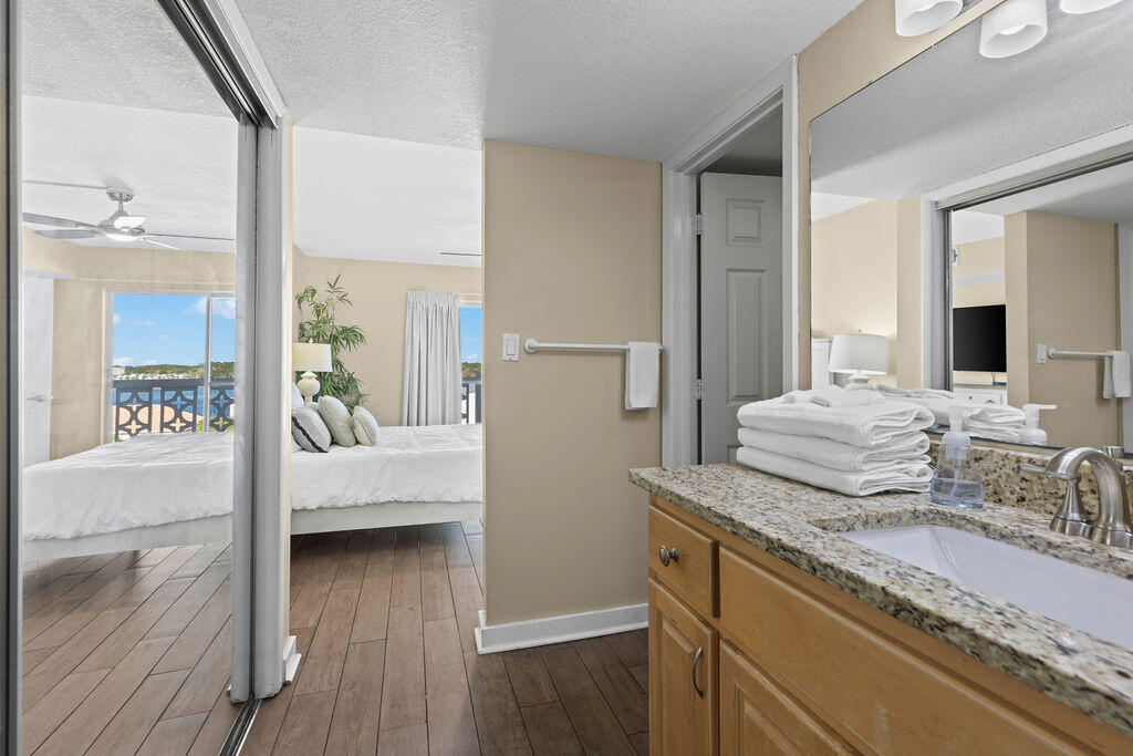 909 Santa Rosa Boulevard, Unit 569 Fort Walton Beach, FL 32548 - Photo 29 of 57 a bathroom with a granite countertop sink and a mirror