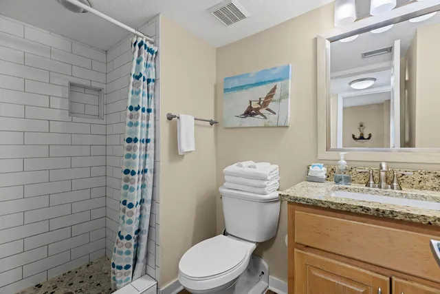 a kitchen with stainless steel appliances granite countertop a sink a stove cabinets and a window