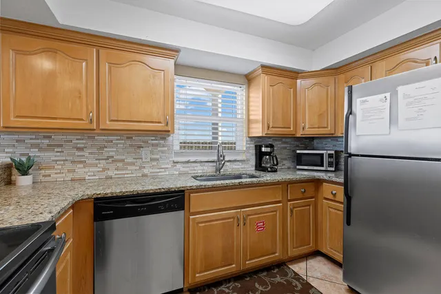 a kitchen with granite countertop a sink and a window