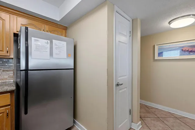 a kitchen with stainless steel appliances granite countertop a refrigerator a stove and a sink