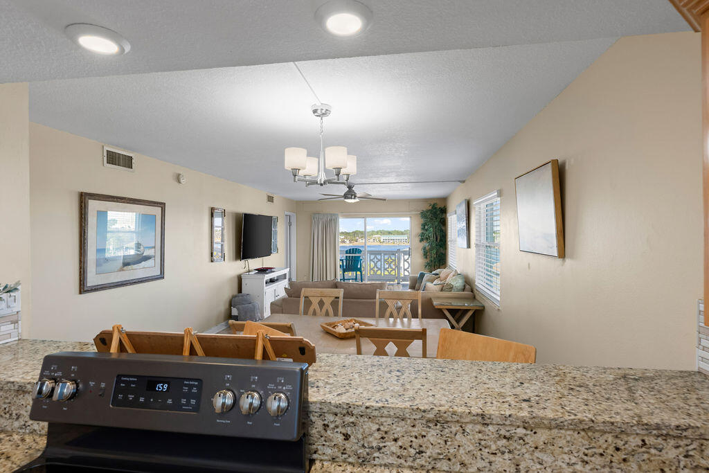 909 Santa Rosa Boulevard, Unit 569 Fort Walton Beach, FL 32548 - Photo 35 of 57 a living room with furniture and a chandelier