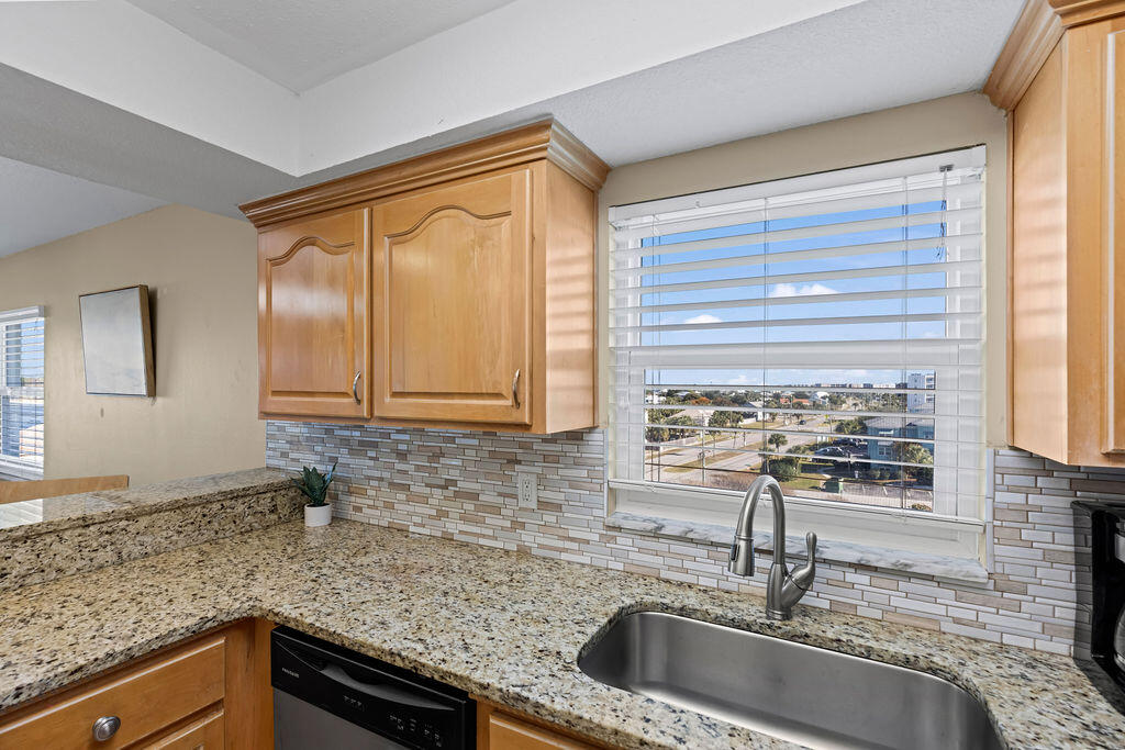 909 Santa Rosa Boulevard, Unit 569 Fort Walton Beach, FL 32548 - Photo 36 of 57 a kitchen with granite countertop a sink and a window
