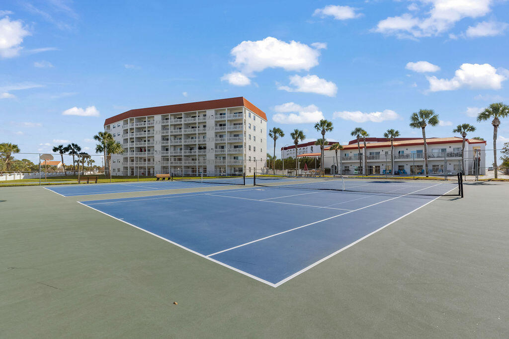 909 Santa Rosa Boulevard, Unit 569 Fort Walton Beach, FL 32548 - Photo 43 of 57 a view of a tennis ground with large trees