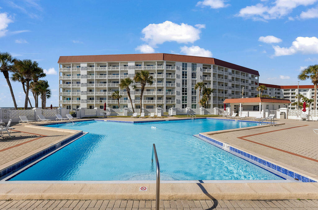 909 Santa Rosa Boulevard, Unit 569 Fort Walton Beach, FL 32548 - Photo 49 of 57 a view of a swimming pool with a lounge chair