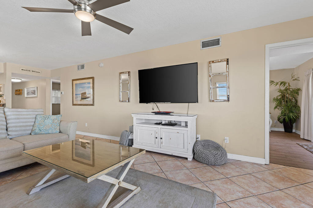 909 Santa Rosa Boulevard, Unit 569 Fort Walton Beach, FL 32548 - Photo 7 of 57 a living room with furniture and a flat screen tv