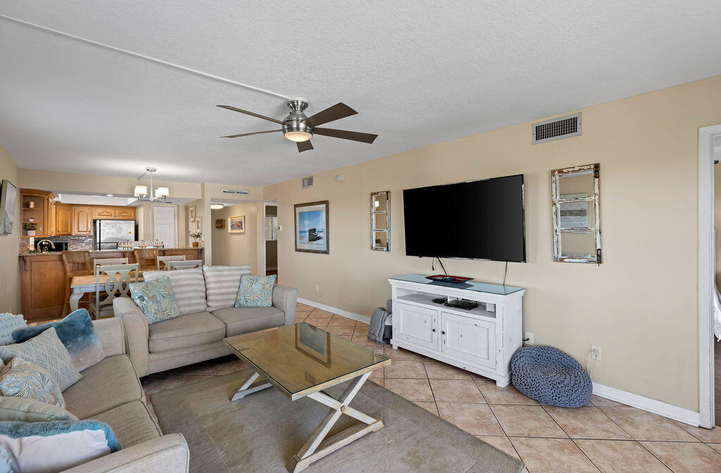 909 Santa Rosa Boulevard, Unit 569 Fort Walton Beach, FL 32548 - Photo 8 of 57 a living room with furniture and a flat screen tv