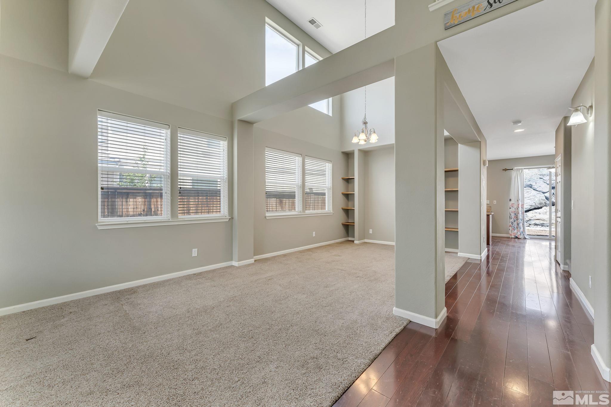 3720 Thistledown Court Reno, NV 89512 - Photo 2 of 8 a view of an empty room with wooden floor and a window