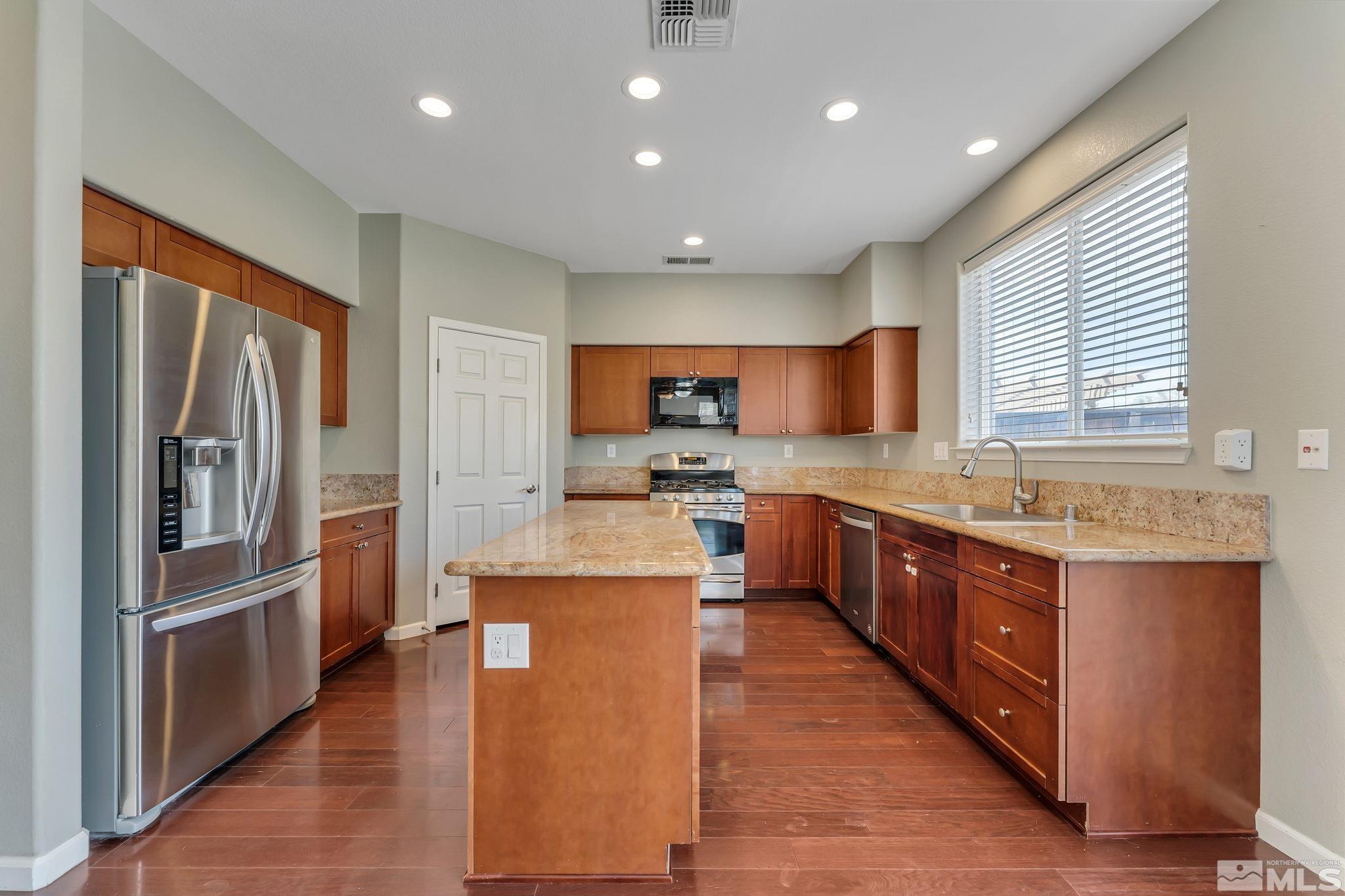 3720 Thistledown Court Reno, NV 89512 - Photo 5 of 8 a large kitchen with stainless steel appliances lots of counter top space