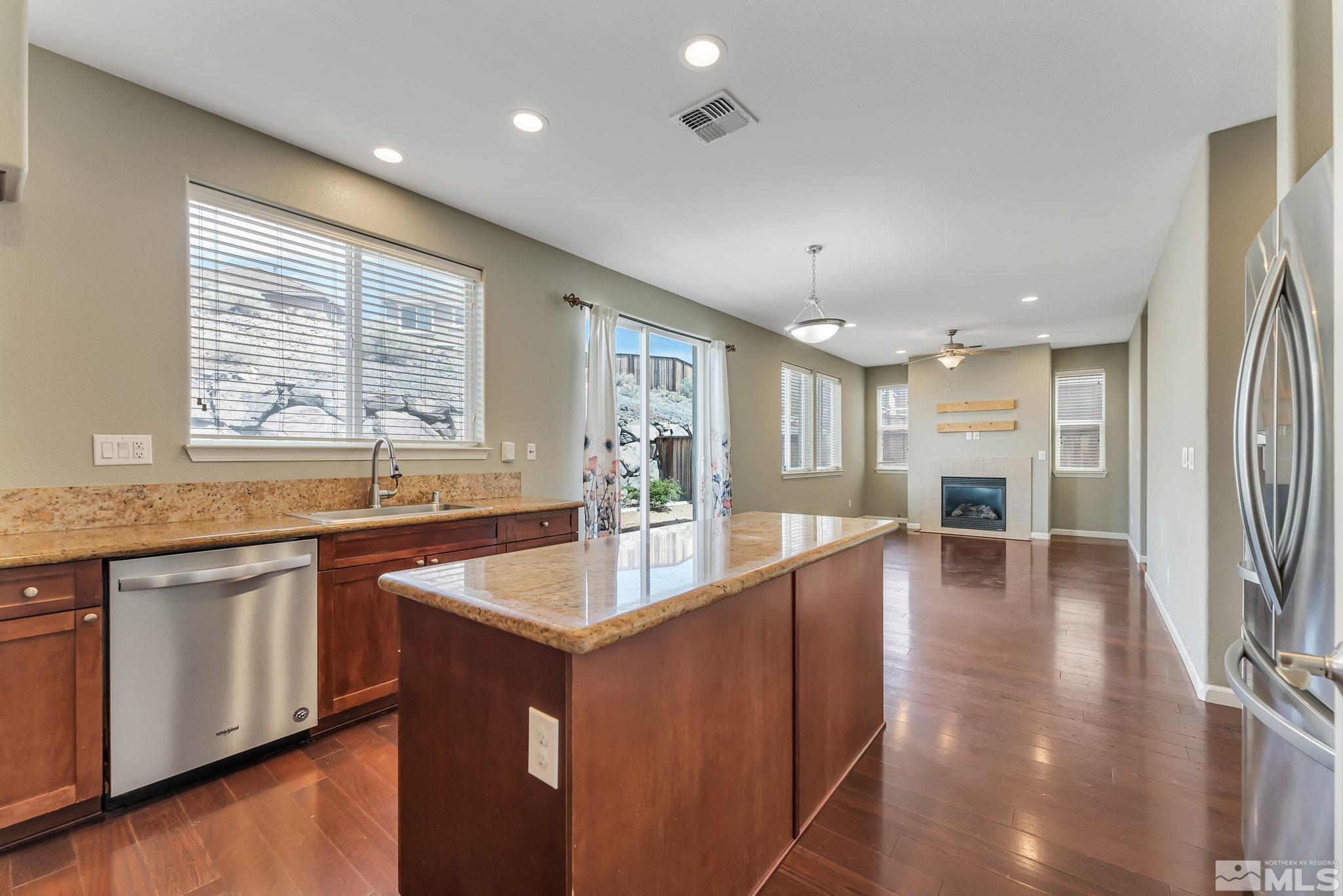 3720 Thistledown Court Reno, NV 89512 - Photo 7 of 8 a large kitchen with kitchen island granite countertop a large window