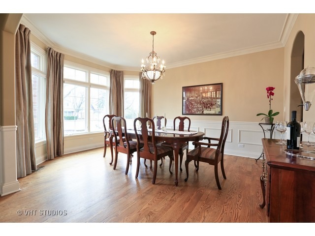 888 Spring Road Elmhurst, IL 60126 - Photo 3 of 22 a view of a dining room with furniture and chandelier