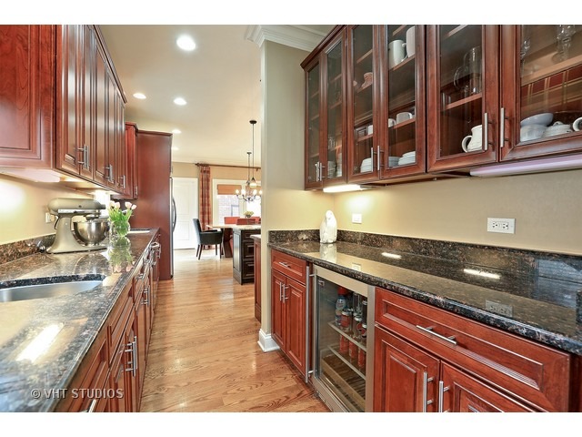 888 Spring Road Elmhurst, IL 60126 - Photo 4 of 22 a kitchen with lots of counter top space and wooden floor