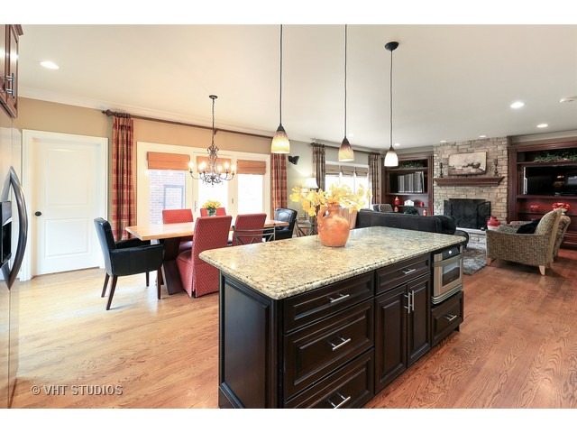 888 Spring Road Elmhurst, IL 60126 - Photo 6 of 22 a kitchen with a stove a sink a dining table and chairs