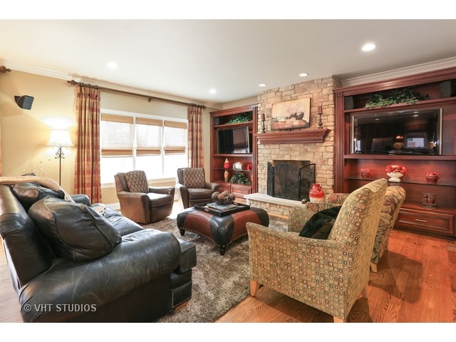 888 Spring Road Elmhurst, IL 60126 - Photo 8 of 22 a living room with fireplace furniture and a flat screen tv
