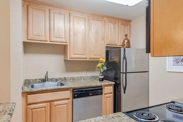 a kitchen with a refrigerator and a sink