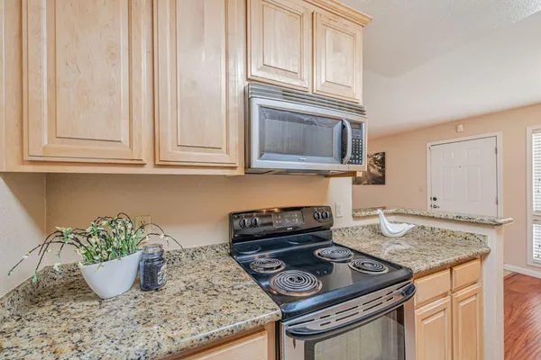a kitchen with a stove and cabinets