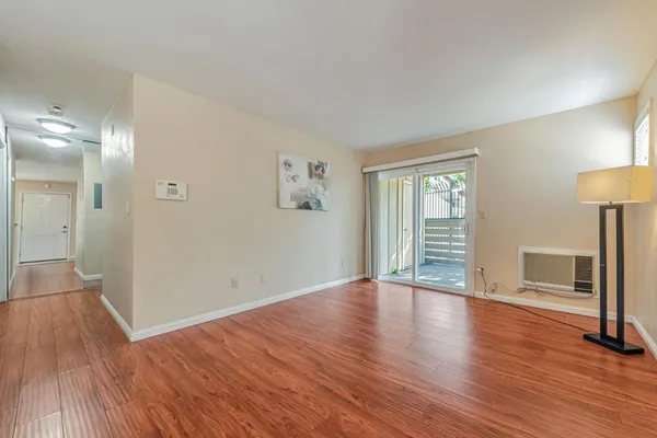 wooden floor in an empty room with a window