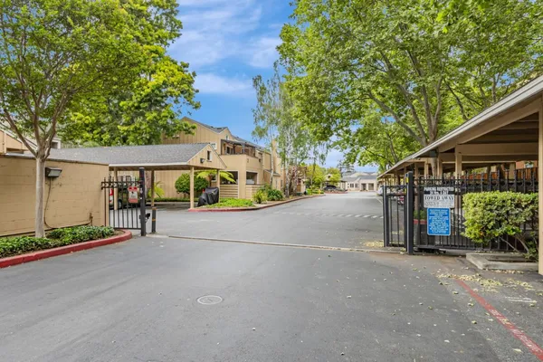 a view of a street with a building and table in front of it