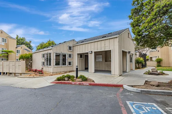 a front view of a house with sitting area