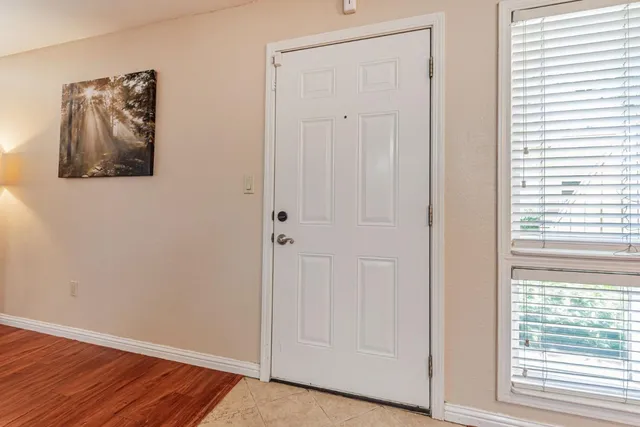 a view of a small space with wooden floor and a window