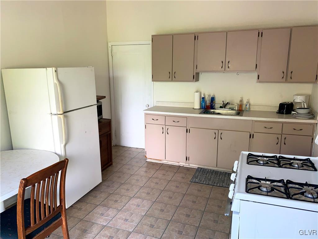 30 North Main Street Bangor, PA 18013 - Photo 12 of 13 a kitchen with a white cabinets and white appliances