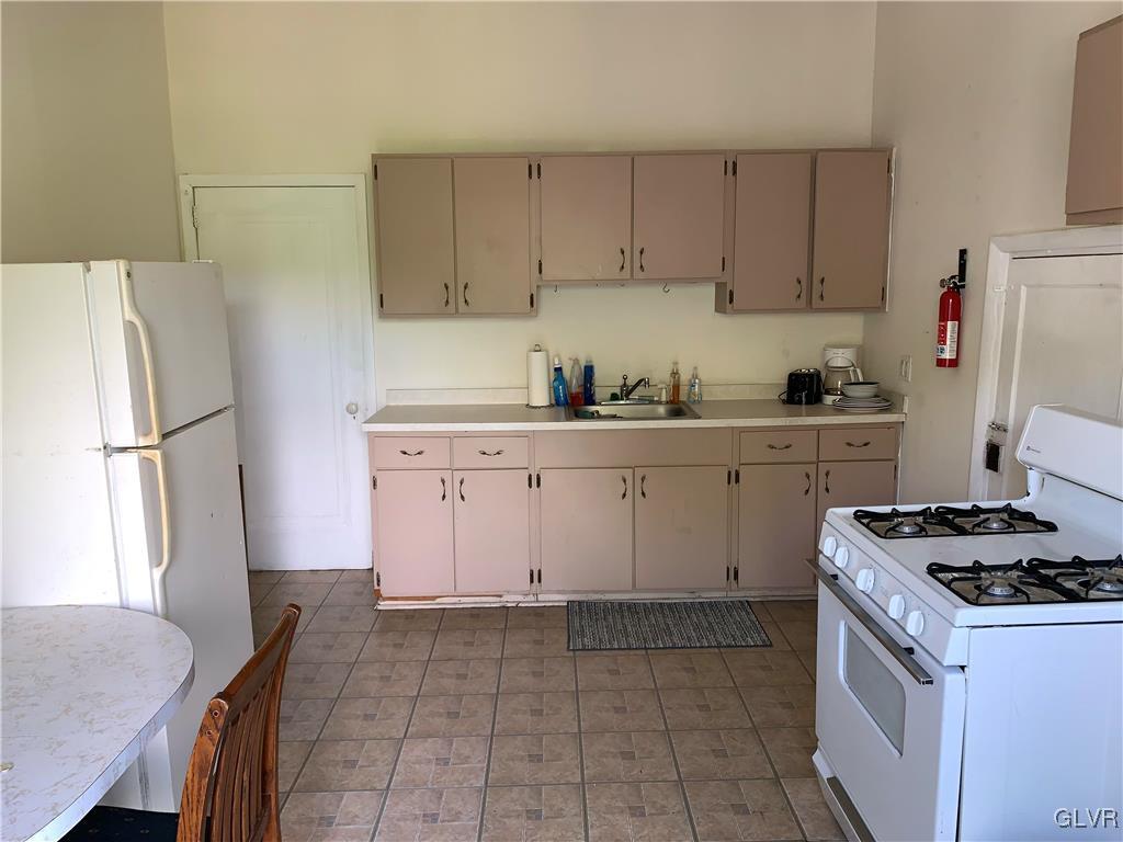 30 North Main Street Bangor, PA 18013 - Photo 6 of 13 a kitchen with a stove a refrigerator and a sink
