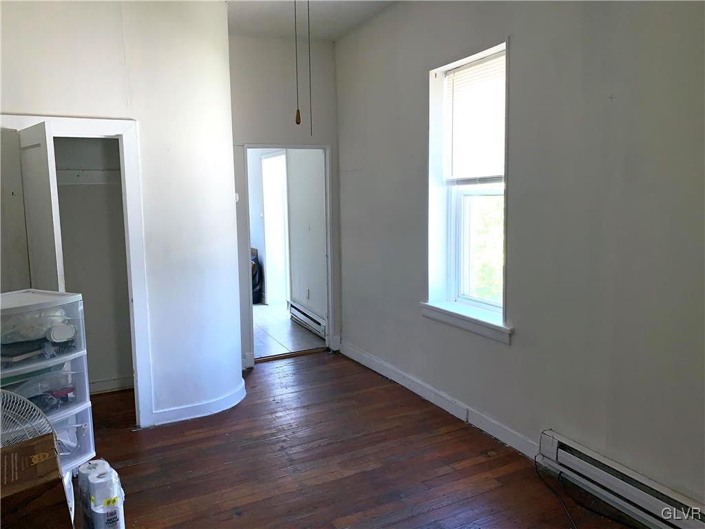30 North Main Street Bangor, PA 18013 - Photo 7 of 13 an empty room with wooden floor and windows