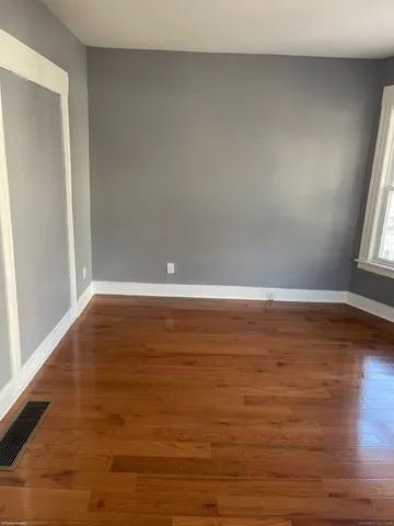 a view of room with window and wooden floor