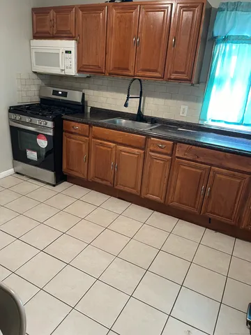 a kitchen with stainless steel appliances a sink dishwasher stove and cabinets