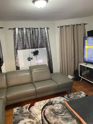 a living room with a couch and a flat screen tv