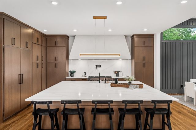 a view of a hallway with wooden cabinets