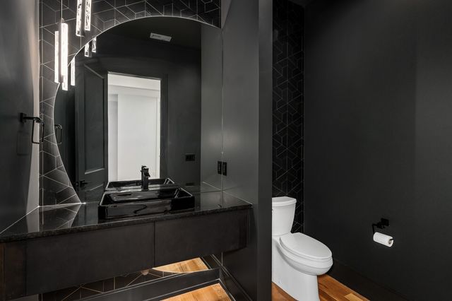 a view of a big room with wooden floor and a kitchen space