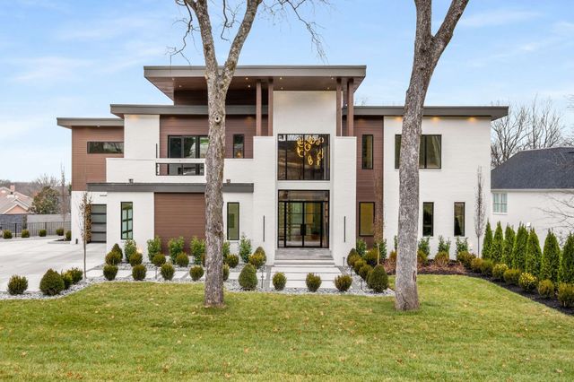 a view of a city with tall buildings and a big yard