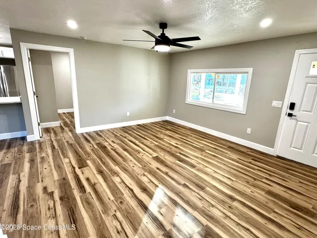 wooden floor in an empty room with a window