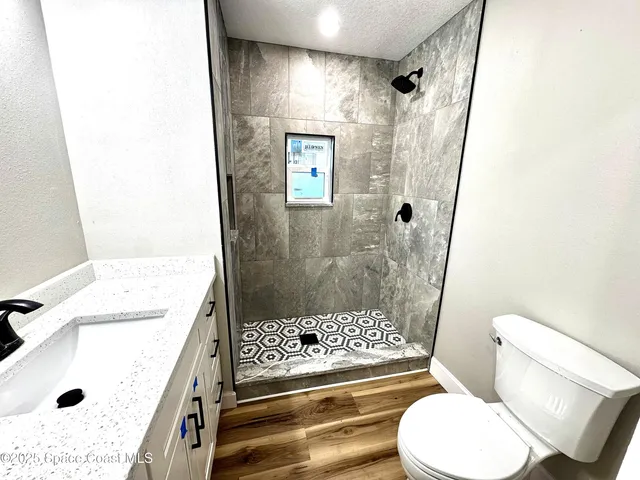 a bathroom with a sink toilet and shower