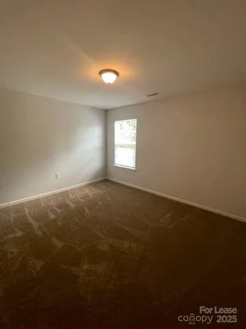 an empty room with a empty space and windows