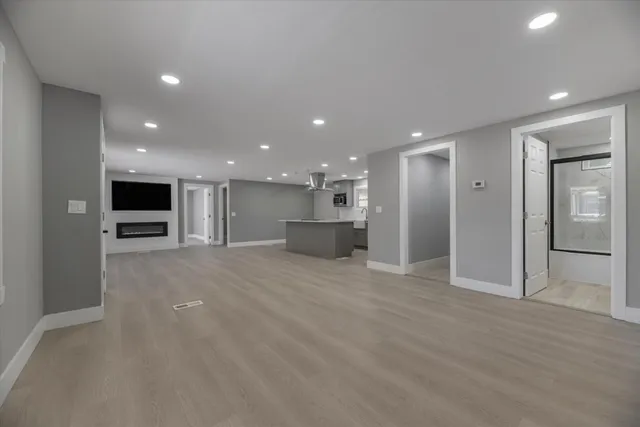 a view of a kitchen with a refrigerator and a kitchen counter top