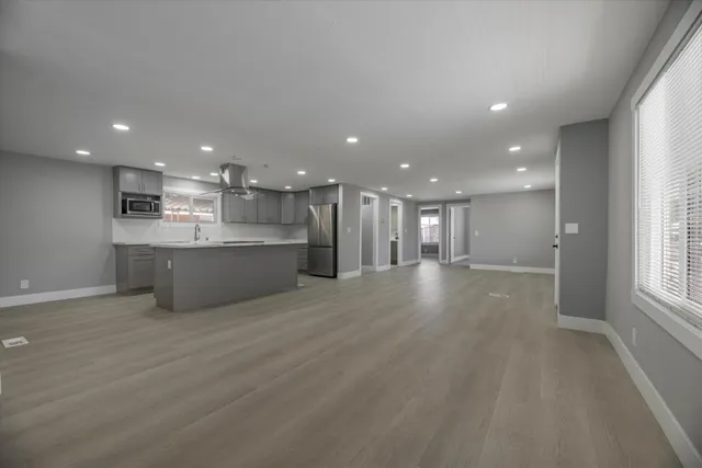 a view of a kitchen with a sink and a large window