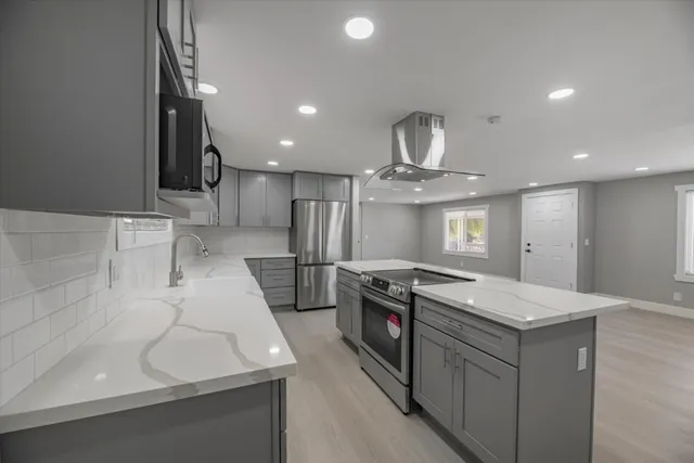 a kitchen that has a sink a stove and a refrigerator