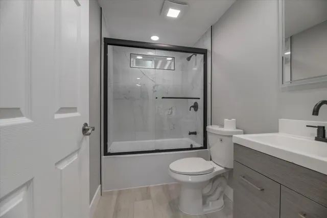a bathroom with a toilet a sink and shower
