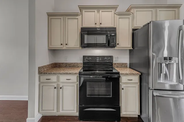 an empty room with windows and chandelier fan