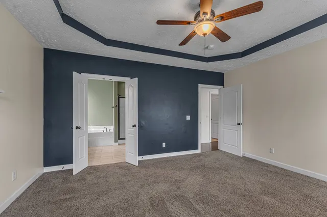 a bathroom with a tub a sink and mirror