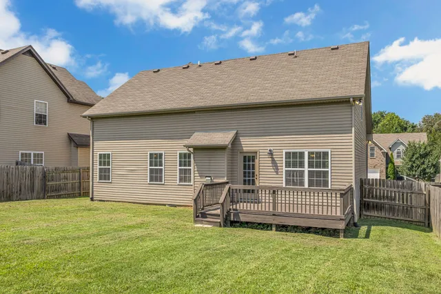 a view of a house with a backyard and a patio