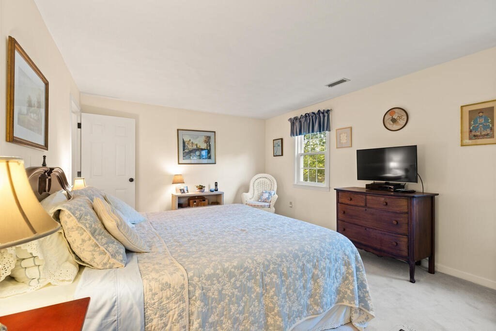 7 Apple Ridge Road, Unit 2 Maynard, MA 01754 - Photo 13 of 27 a bedroom with a bed and a flat screen tv