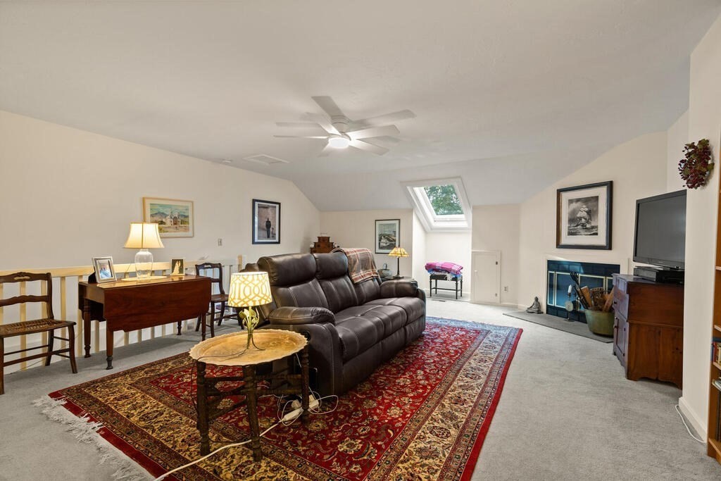 7 Apple Ridge Road, Unit 2 Maynard, MA 01754 - Photo 18 of 27 a living room with furniture a fireplace and a table