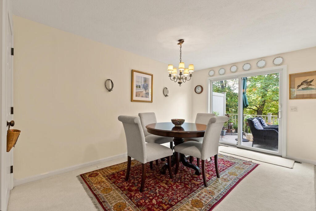 7 Apple Ridge Road, Unit 2 Maynard, MA 01754 - Photo 7 of 27 a view of a dining room with furniture and chandelier