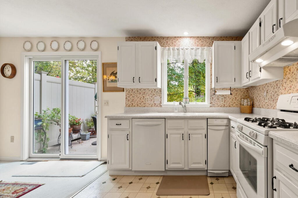 7 Apple Ridge Road, Unit 2 Maynard, MA 01754 - Photo 10 of 27 a kitchen with stainless steel appliances a white cabinets and a stove top oven