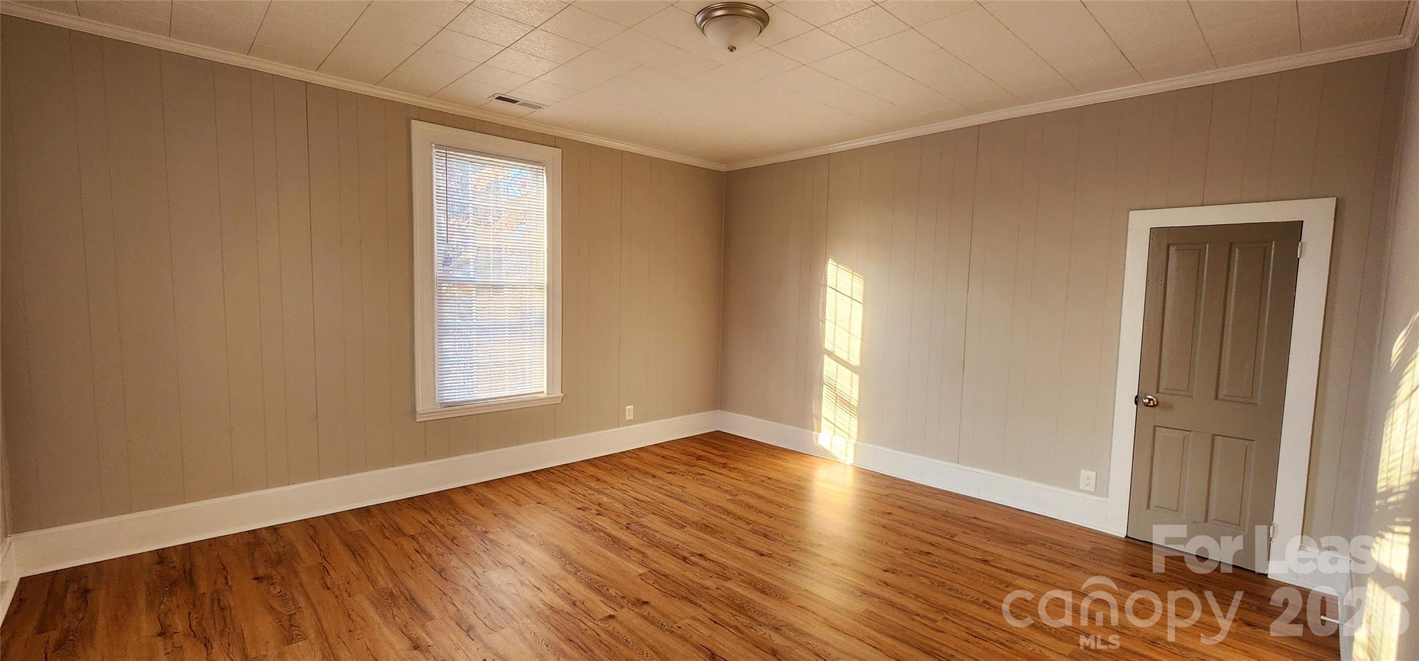 359 Flat Rock Road Lawndale, NC 28090 - Photo 16 of 19 a view of an empty room with wooden floor and a window